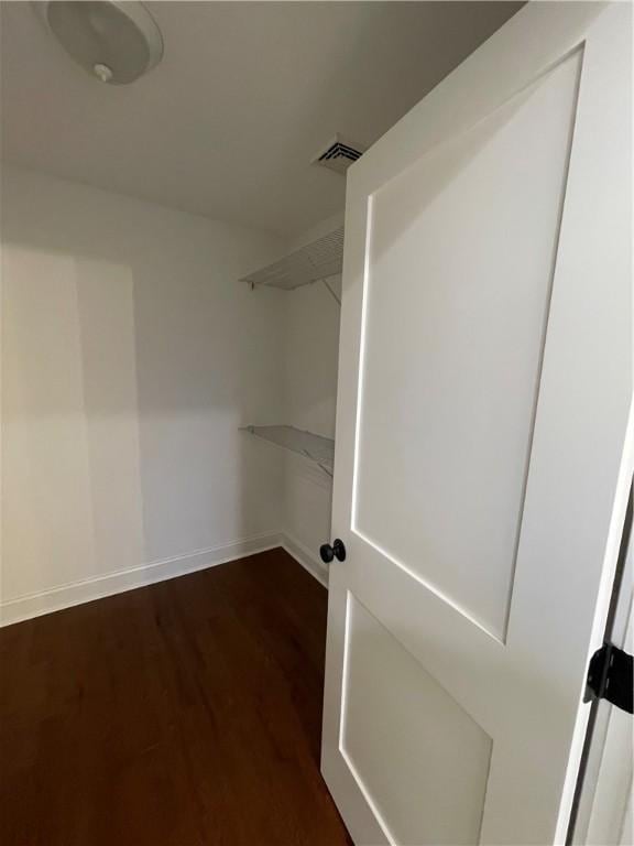 walk in closet featuring dark hardwood / wood-style flooring