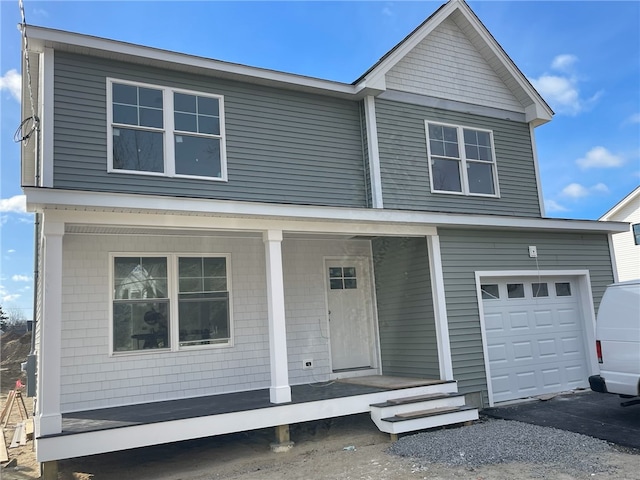 front of property with covered porch and a garage