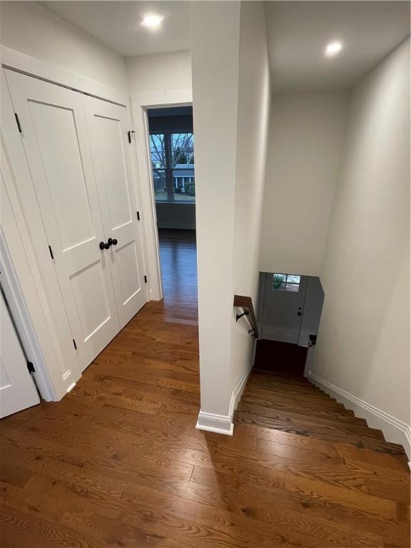 hallway with dark hardwood / wood-style flooring