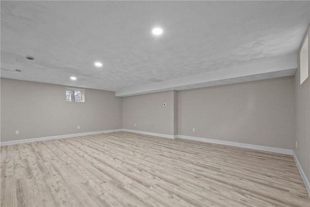 basement with light hardwood / wood-style floors