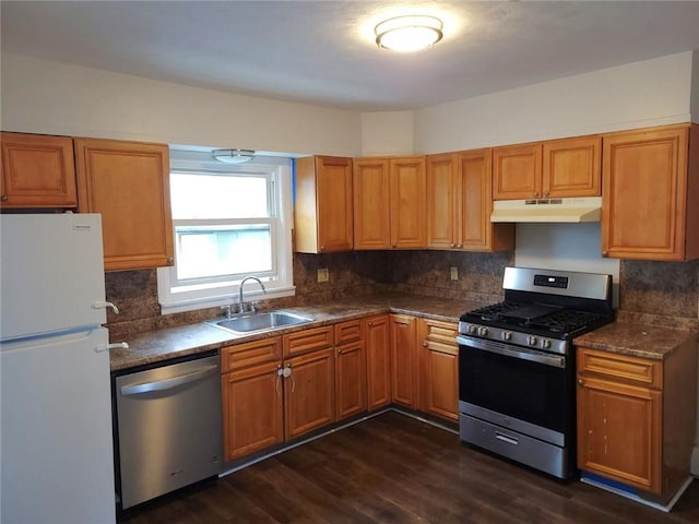 kitchen with tasteful backsplash, dark hardwood / wood-style flooring, sink, and stainless steel appliances