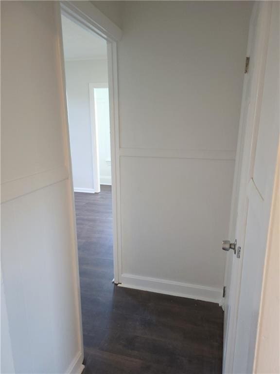 hallway with dark hardwood / wood-style flooring