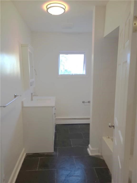 bathroom with vanity, a baseboard radiator, and tub / shower combination