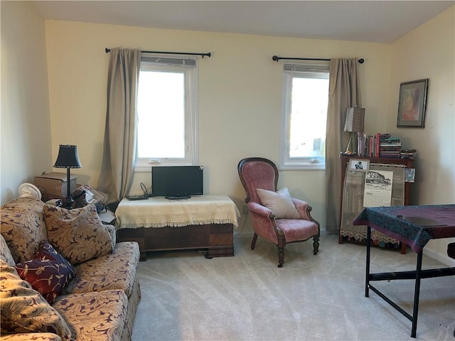 sitting room featuring plenty of natural light and light carpet