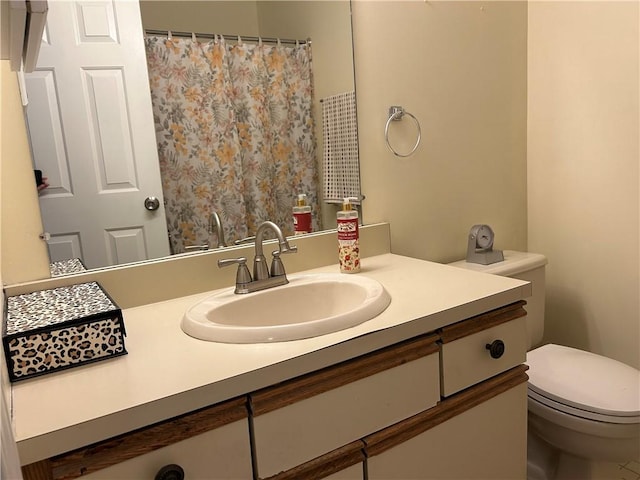 bathroom with toilet and vanity