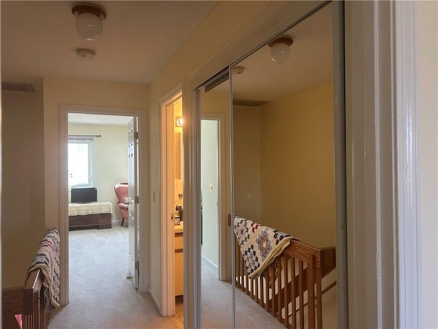 hallway with light colored carpet