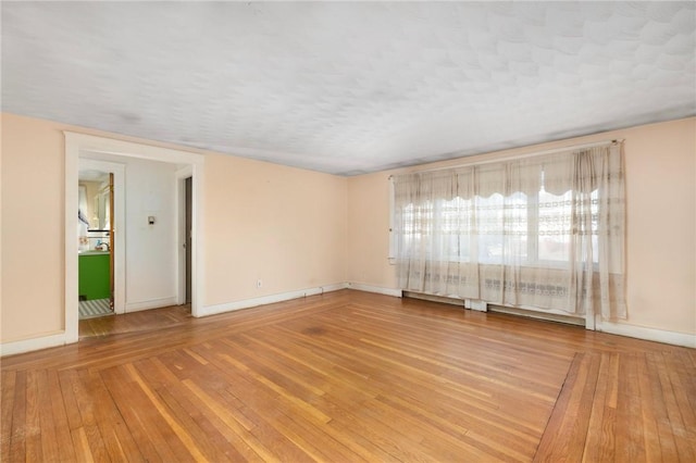 spare room with hardwood / wood-style floors