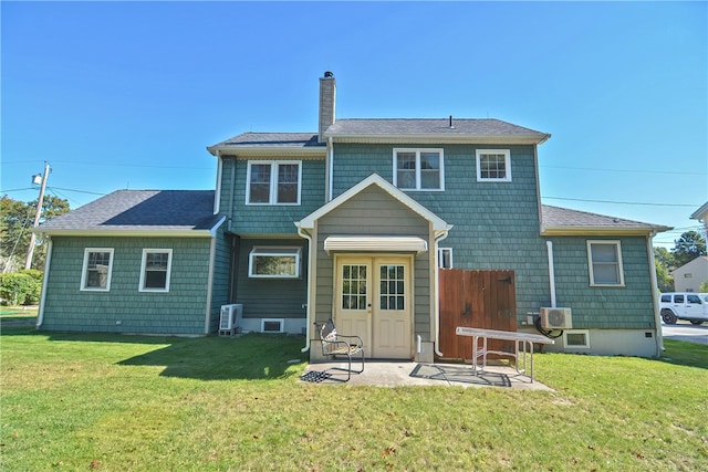 back of house with a patio area and a yard