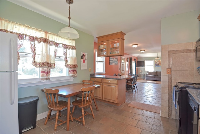 dining area featuring plenty of natural light and tile patterned flooring