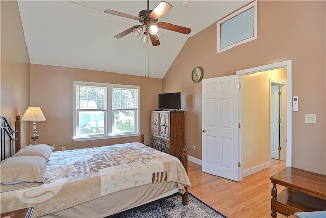 bedroom with ceiling fan, light wood-type flooring, and lofted ceiling