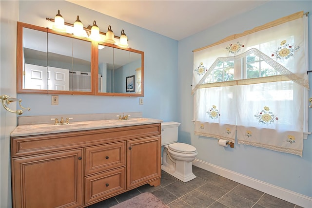 bathroom with tile patterned floors, vanity, and toilet