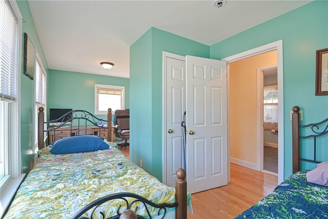 bedroom with light wood-type flooring and a closet