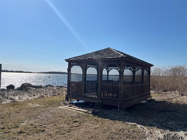 view of dock featuring a gazebo and a water view