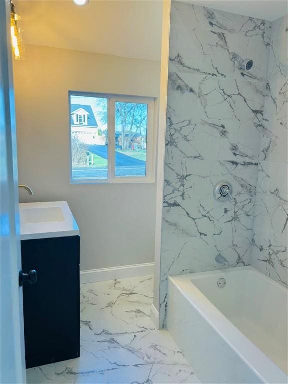 bathroom featuring vanity and tiled shower / bath