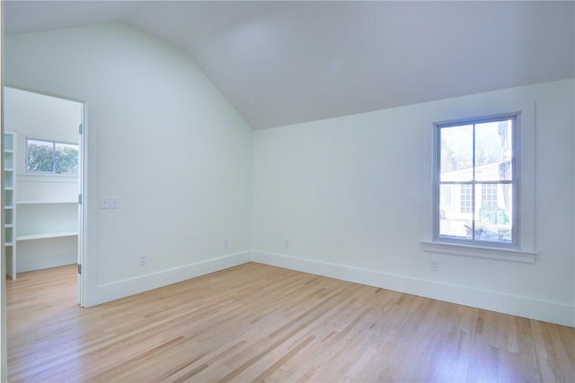 bonus room featuring vaulted ceiling, a wealth of natural light, and light hardwood / wood-style flooring