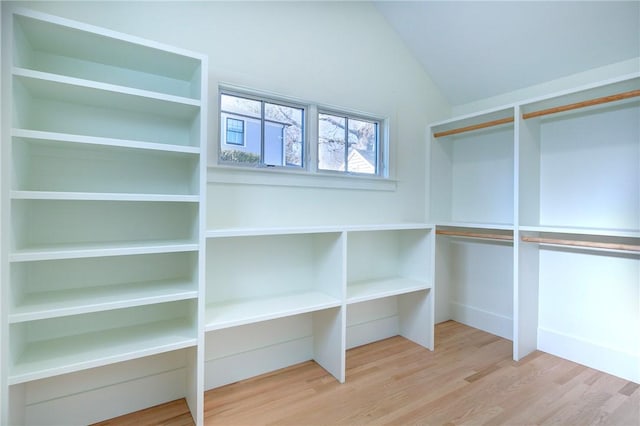 spacious closet featuring hardwood / wood-style flooring and lofted ceiling