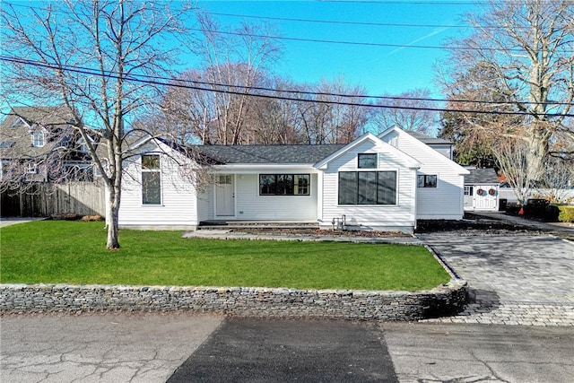 ranch-style home with a front lawn