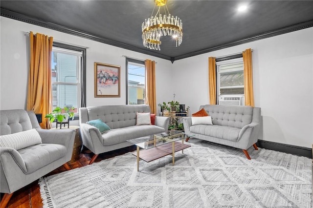 living room featuring light wood-type flooring, an inviting chandelier, and ornamental molding