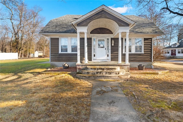 bungalow-style home with a front yard