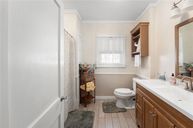 bathroom with vanity, toilet, and ornamental molding