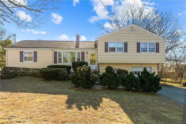 tri-level home featuring a front yard