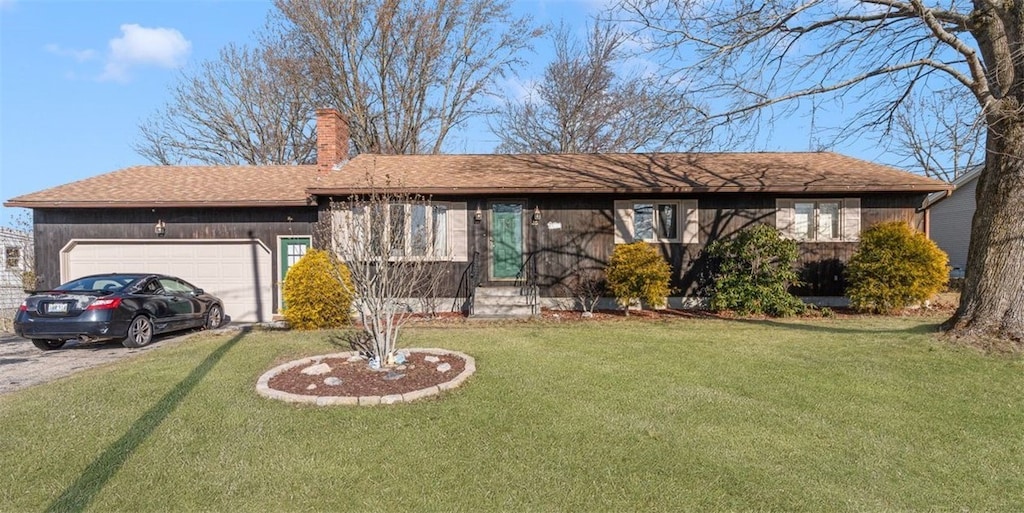 ranch-style home with a garage and a front yard