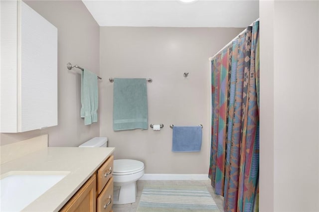 bathroom featuring tile patterned floors, vanity, and toilet