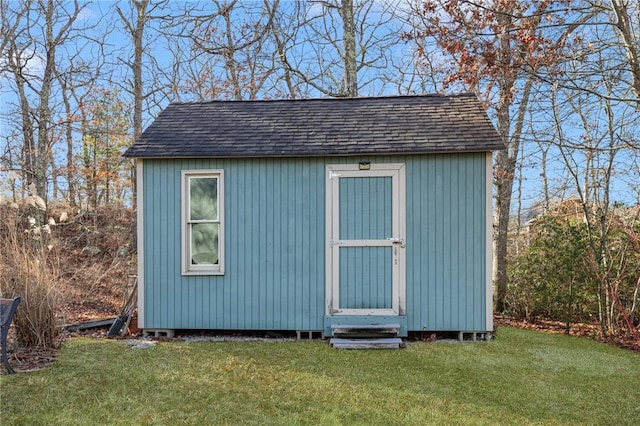 view of outbuilding featuring a yard