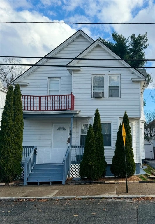 view of front facade with covered porch and a balcony