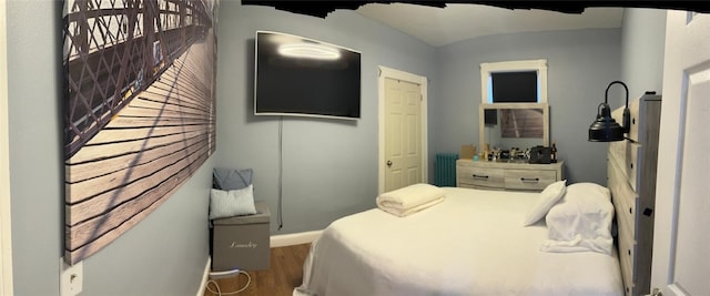 bedroom featuring hardwood / wood-style floors and radiator