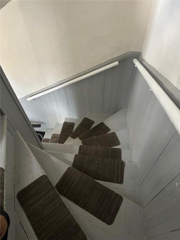 stairs featuring wooden walls