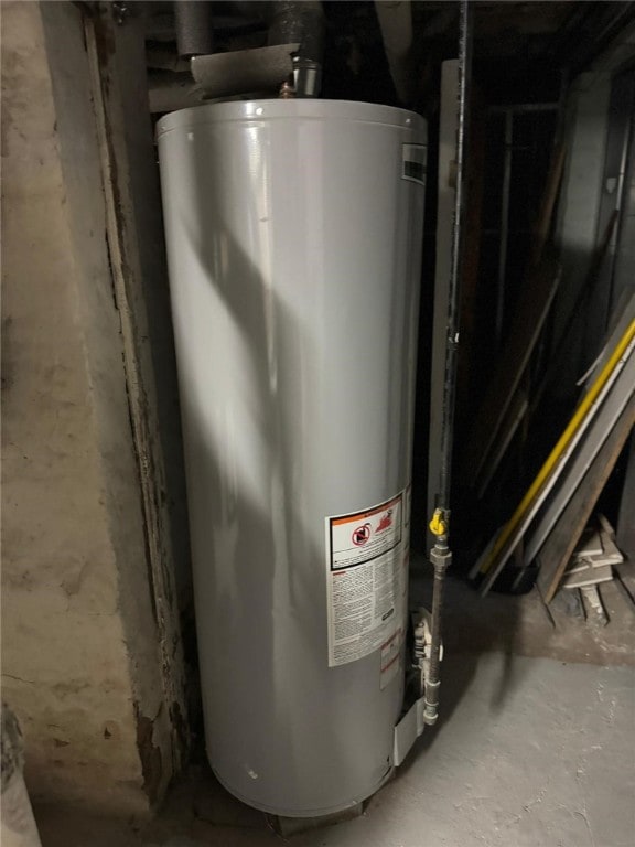 utility room featuring water heater