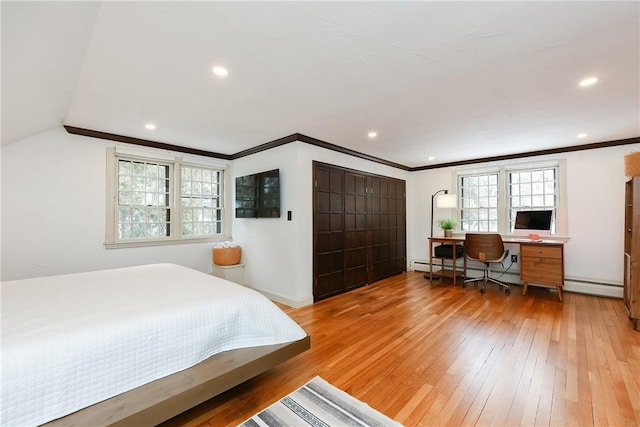 bedroom featuring baseboard heating, wood-type flooring, and lofted ceiling