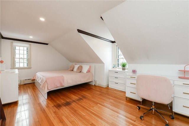 bedroom featuring lofted ceiling, a baseboard heating unit, and light hardwood / wood-style flooring