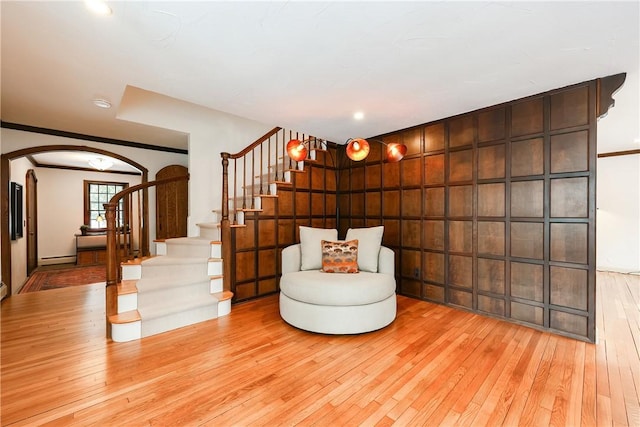 unfurnished room featuring a baseboard heating unit and light hardwood / wood-style floors