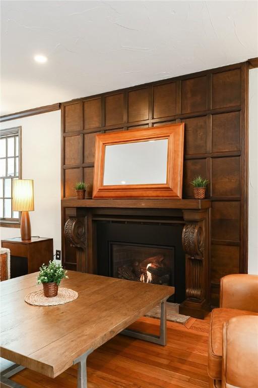 sitting room featuring hardwood / wood-style floors and wooden walls