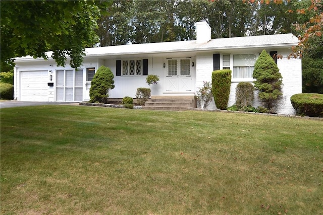 ranch-style house with a garage and a front yard