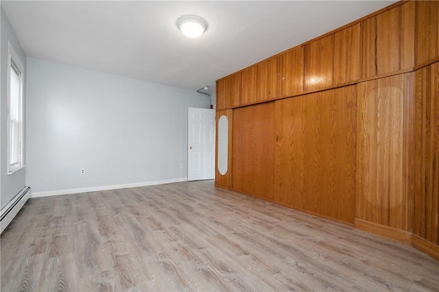 unfurnished bedroom with light hardwood / wood-style floors and a closet