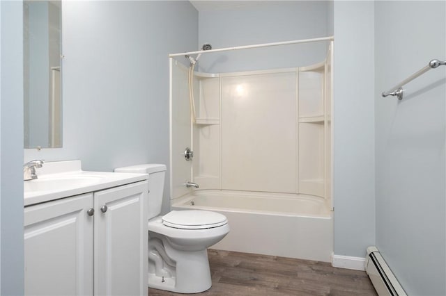 full bathroom featuring hardwood / wood-style floors, vanity, toilet, baseboard heating, and tub / shower combination