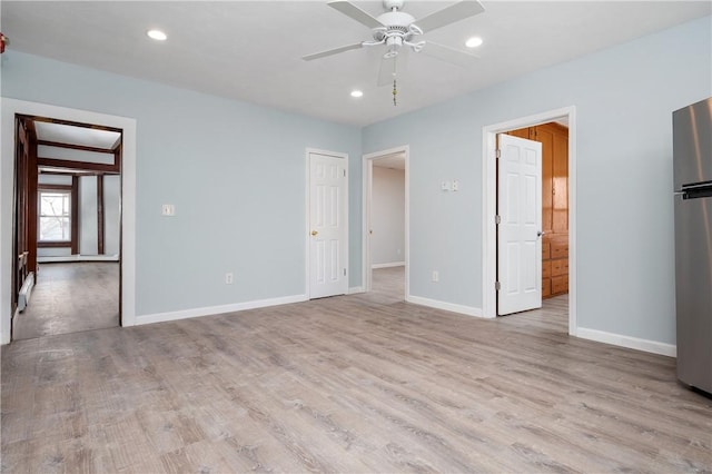 unfurnished bedroom with ceiling fan, light hardwood / wood-style floors, and stainless steel refrigerator