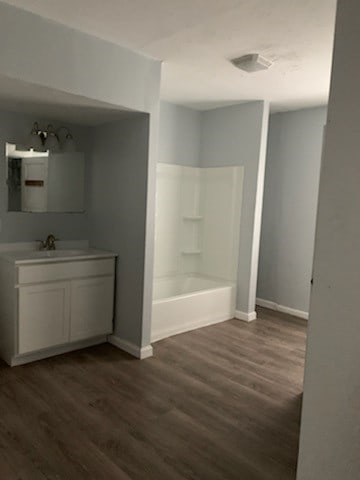 bathroom featuring vanity, shower / bath combination, and hardwood / wood-style flooring