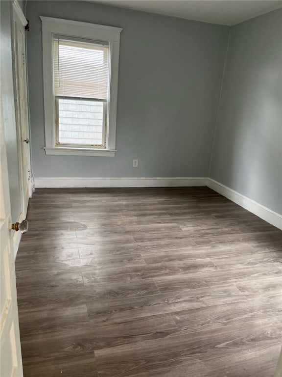 empty room with dark wood-type flooring