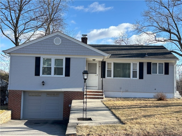 view of front of house with a front yard and a garage