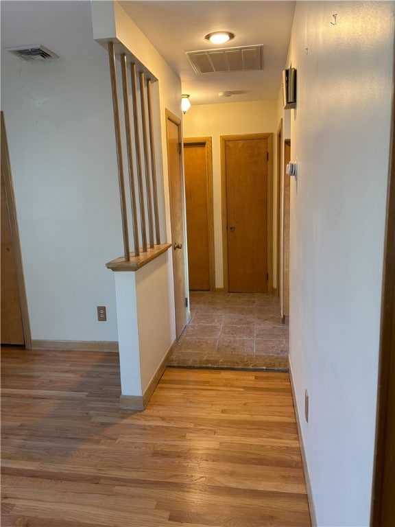 corridor with light wood-type flooring