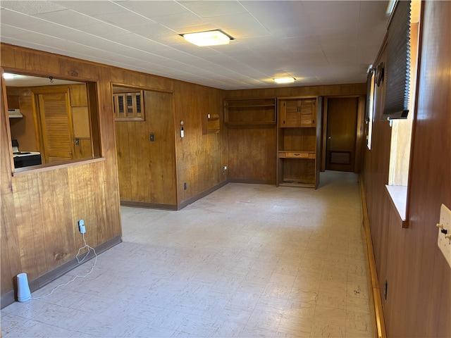 spare room featuring wooden walls