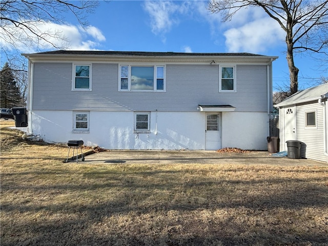 rear view of house featuring a lawn