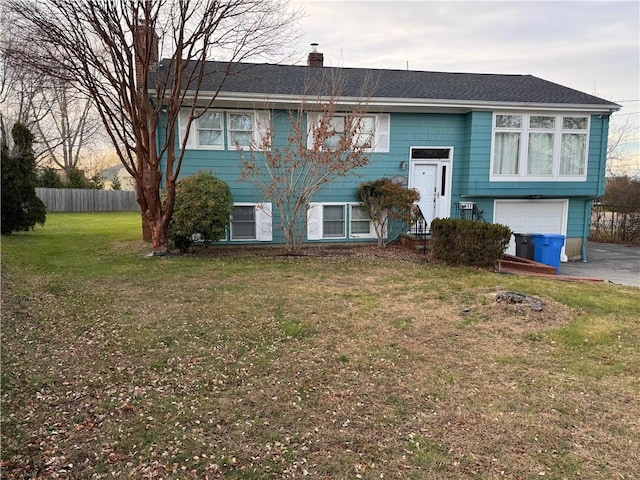 split foyer home with a front lawn and a garage