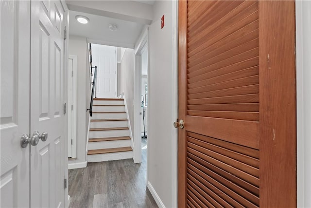 interior space with stairway, wood finished floors, and baseboards