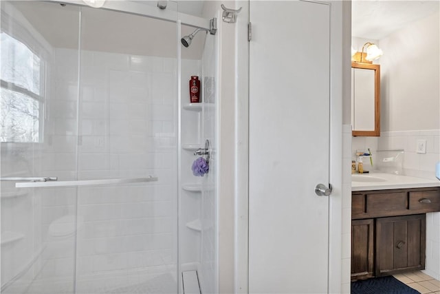 bathroom with a shower stall and vanity