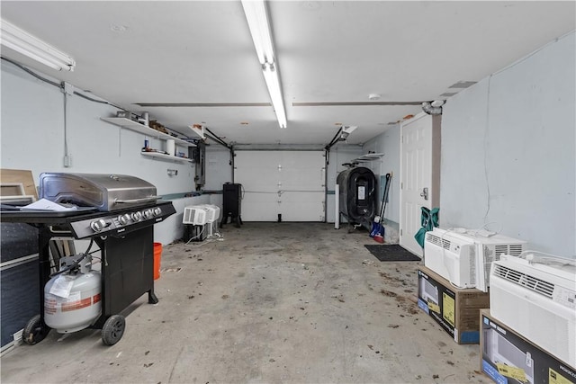 garage featuring a wall mounted air conditioner